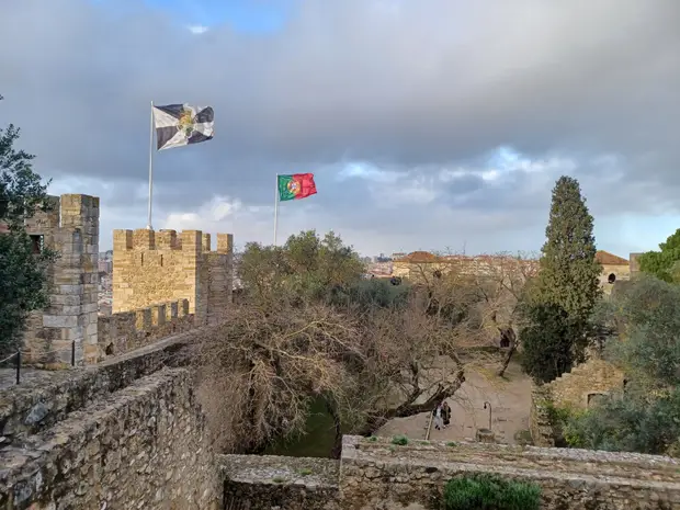 Muralhas do Castelo de São Jorge, em Lisboa, com a bandeira de Portugal